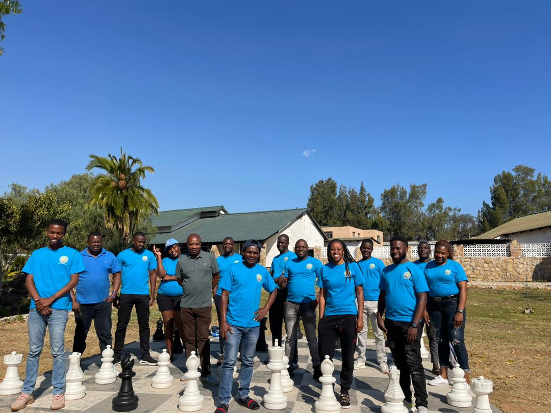 The Hands of Hope team in blue shirts at an outdoor retreat